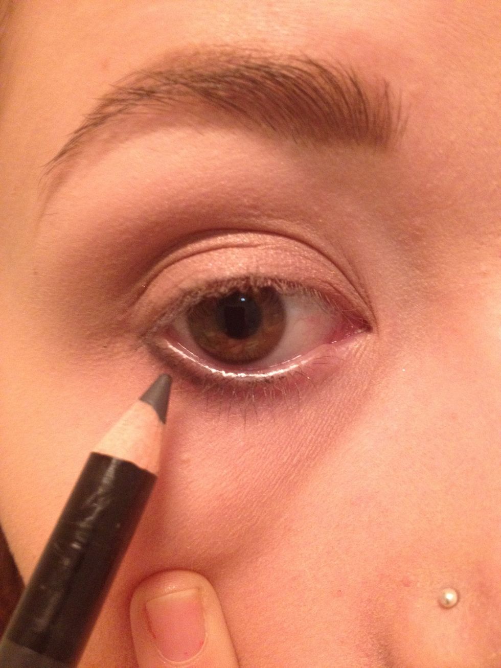 create a line with your eyeliner pull down the skin beneath your eye to get close to the lash line, not too thick! I am using a grey eyeliner, Don't worry about neatness as it won't show when smudged