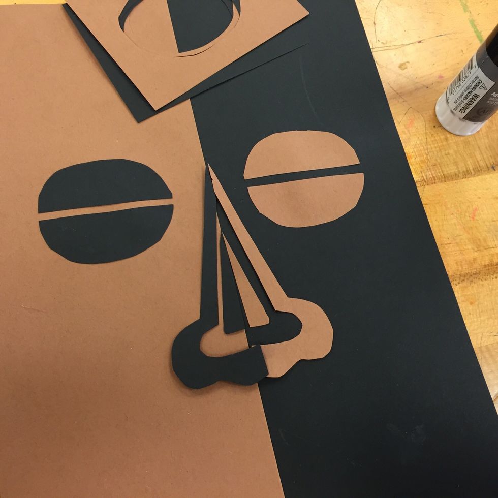 Create a nose by folding and cutting paper.