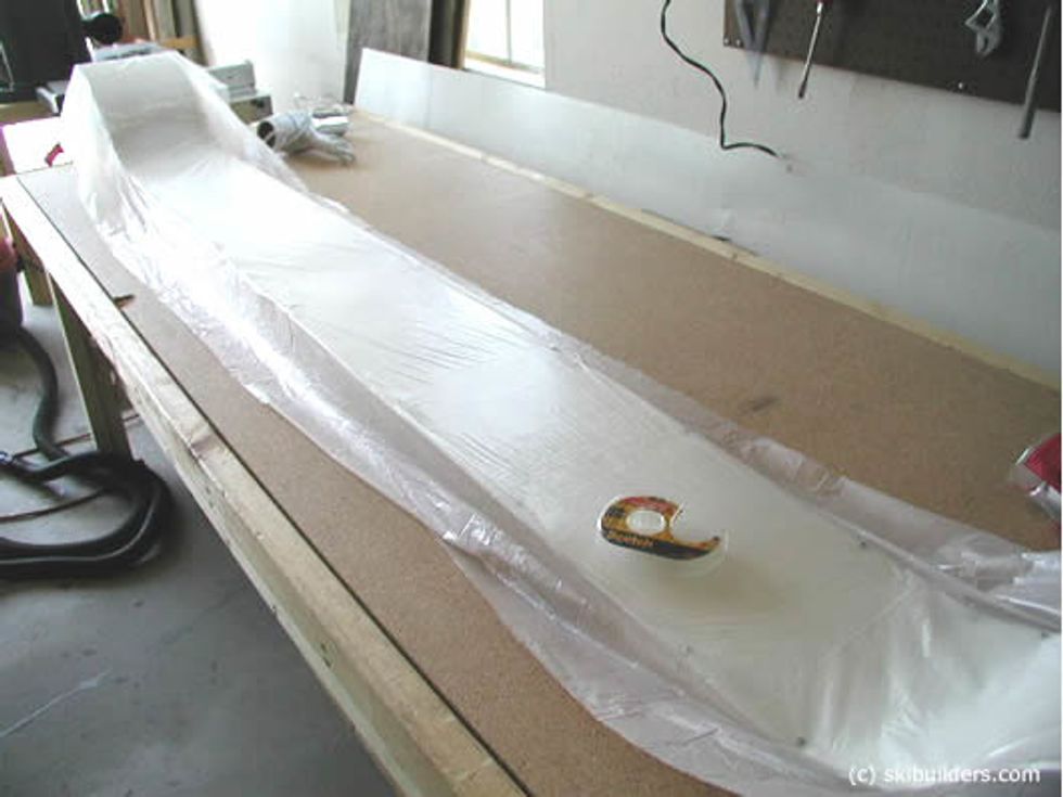Create a plastic bag cover to place over the mold to catch excess epoxy that may come up when pressing