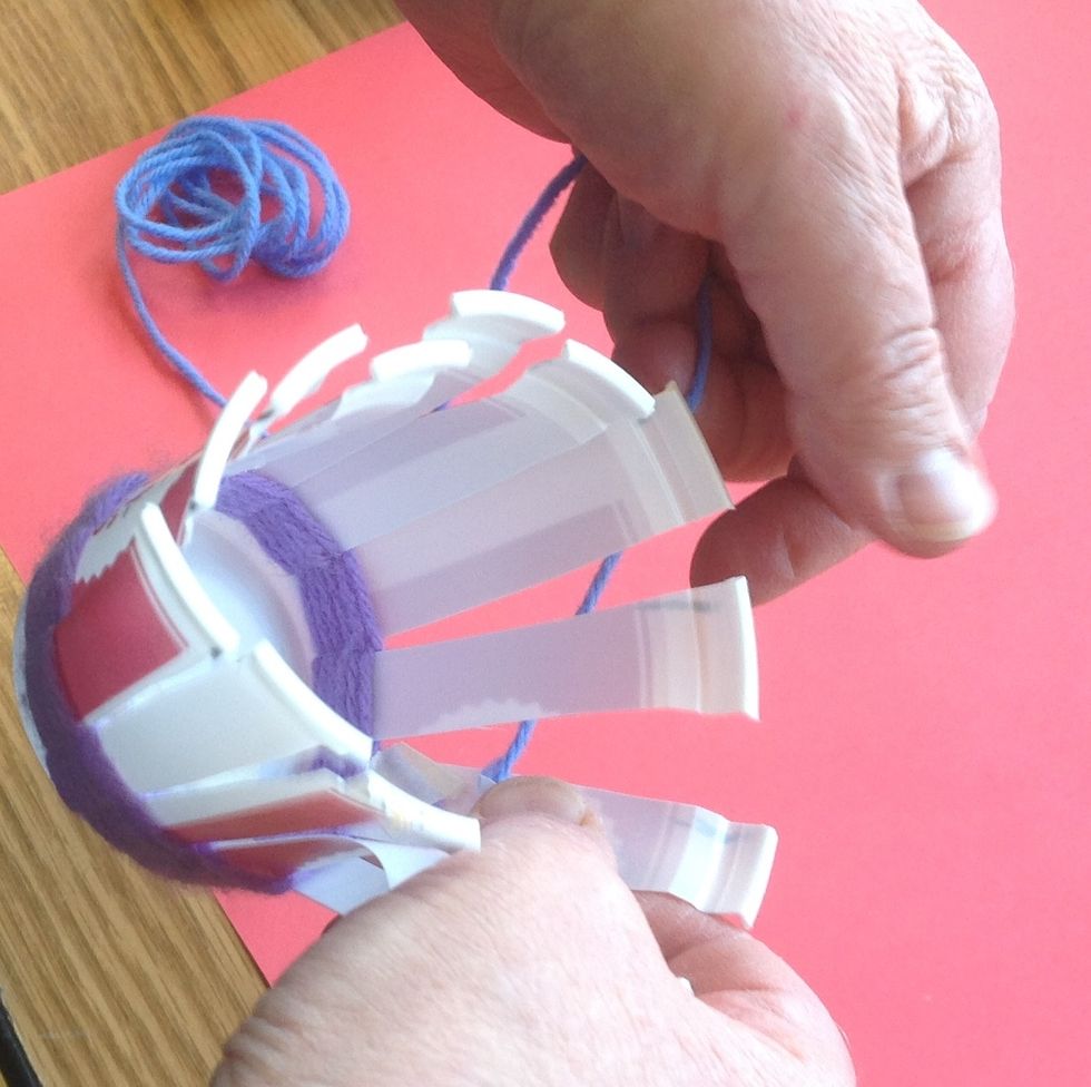 Create a second ball of yarn and tape the end to the same warp. Lead the yarn out through the space the yarn would have come out of had you continued weaving with the previous color.
