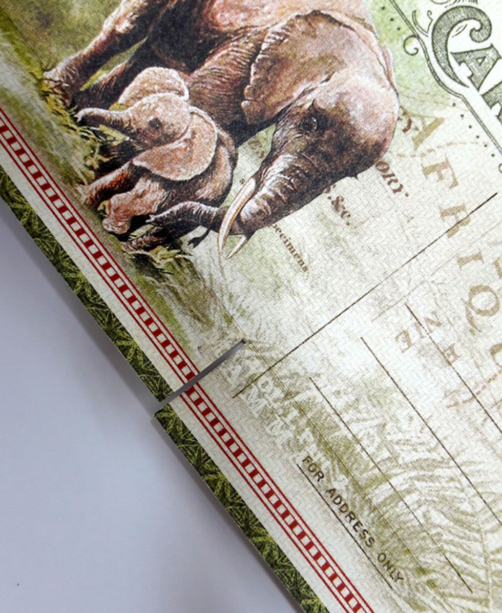 Create a slit in the center of the flap to allow the flap to fit into two pockets and slide on both sides of the connecting seam.