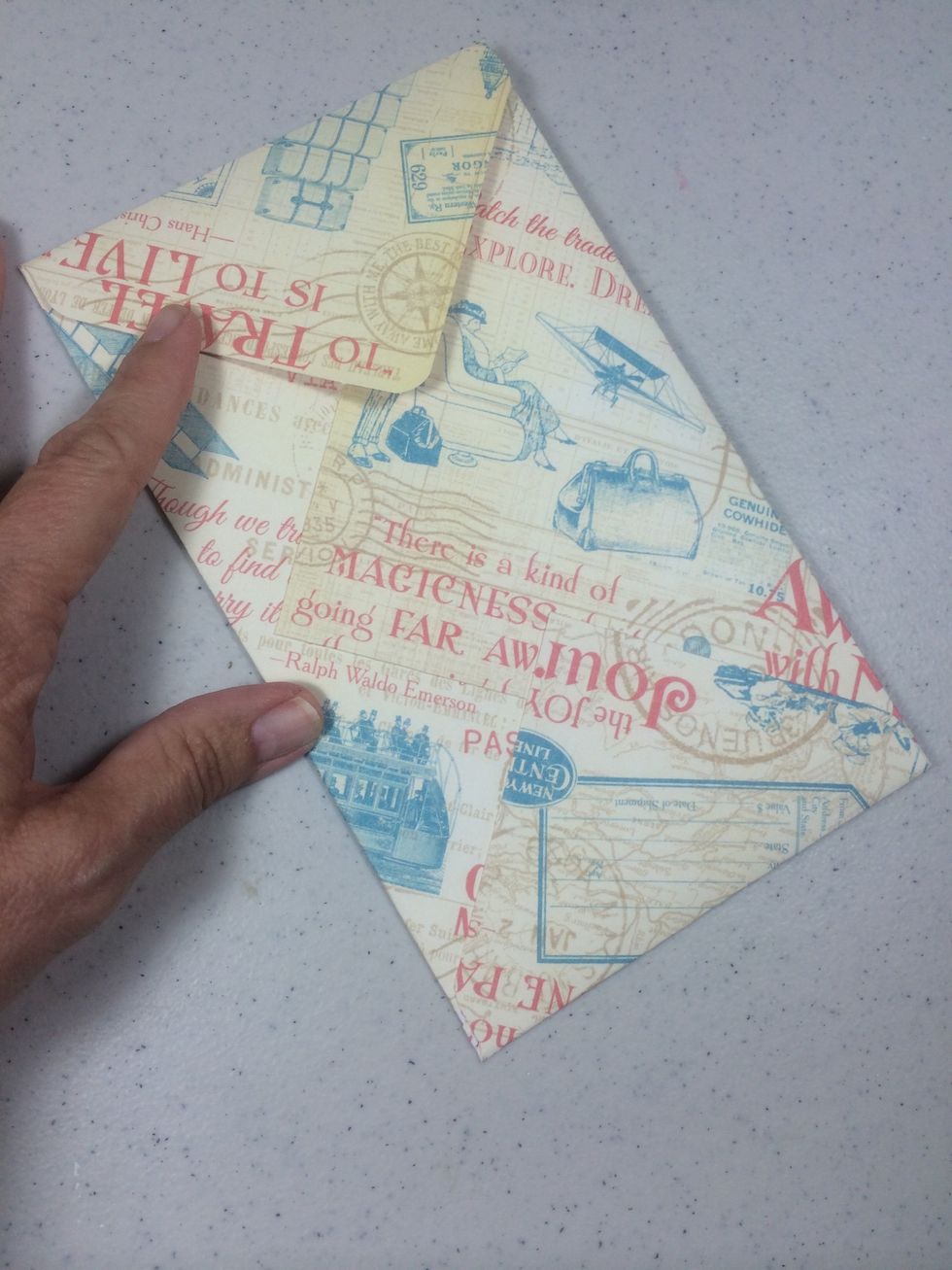 Create a tall envelope for the last interior panel to collect receipts or memorabilia. I created a 4 1/2" x 7 1/2" envelope using the We R Memory Keepers Envelope Punchboard. Adhere into place.