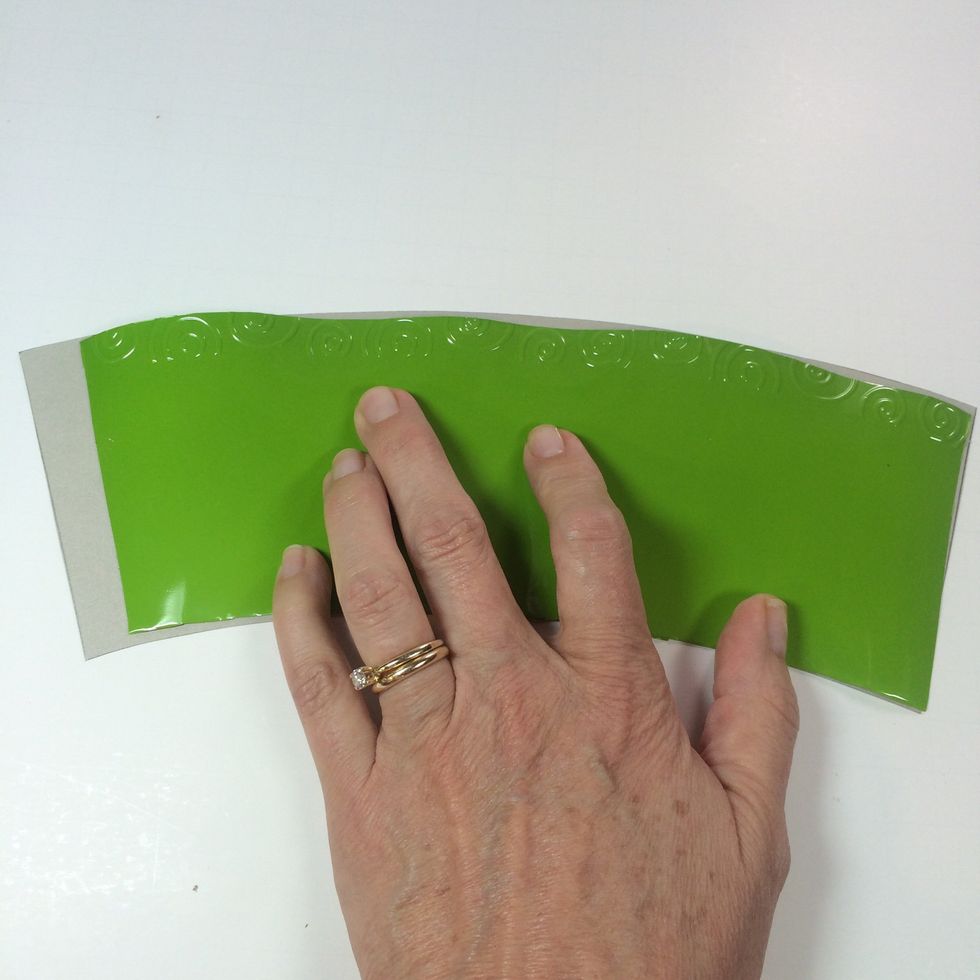 Create a template by tracing the flatten cup onto scrap card stock. Make sure to add an extra 1/2 inch to left end for overlapping.