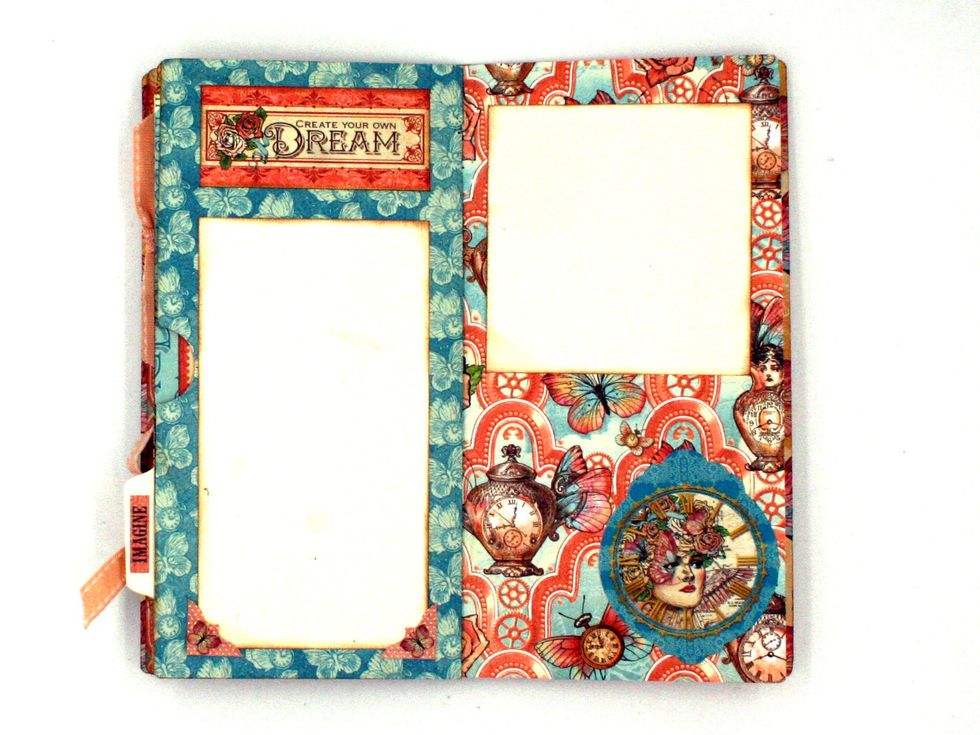 Create a thumb notch on the pocket with a 1" circle punch.  Add a 3 x 5 1/2" photo mat. Add sticker corners at the bottom. Cut "Create Your Own Dream" from Adventure Beckons & glue at the top.