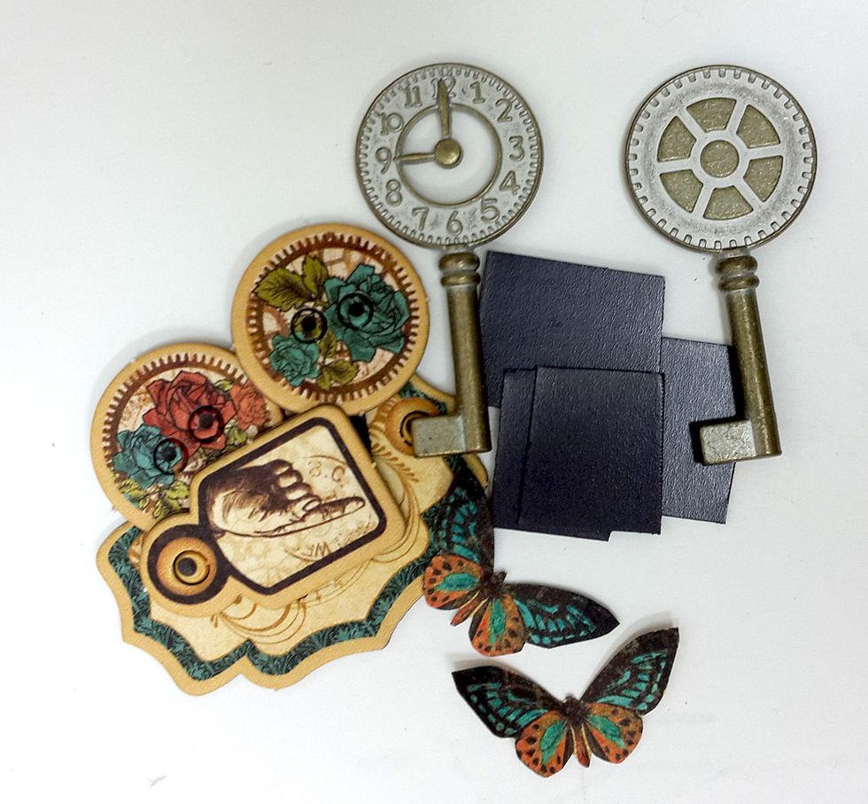 Create decorative magnets to hold your notes from metal keys, chipboard pieces, cut images and flowers. Attach the magnets to the back of the pieces and add flowers and butterflies on the front.
