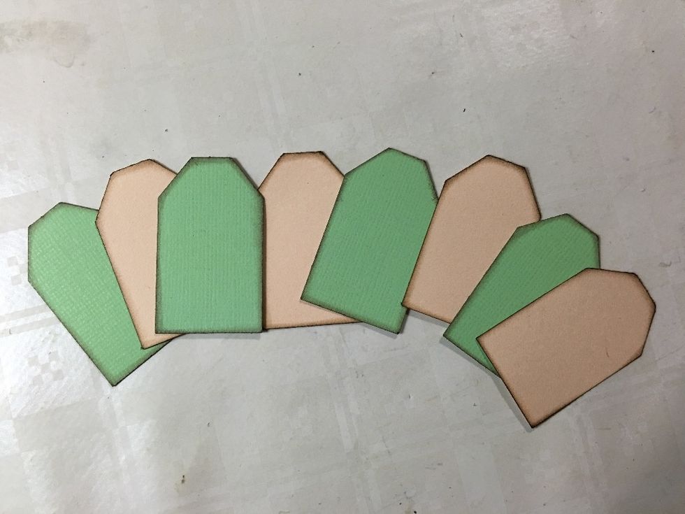Create eight small tags - you can use a tag punch, or cut them yourself. My measurements were 2,5 x 4,5 cm (1 x 1\u00be\u201d). Taper the top corners and ink around the edges.