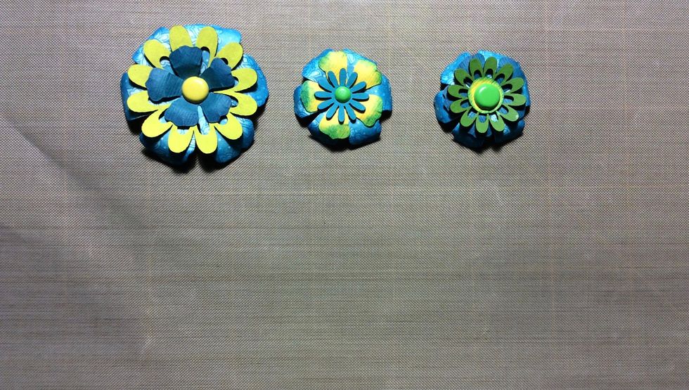 Create flower units, fixing each flower with glue and a brad. You should have 3 flower units in total.