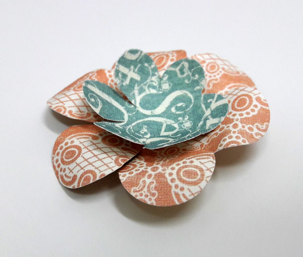 Create flowers by using two sizes of flower punches. Curl petals to give dimension to flowers.