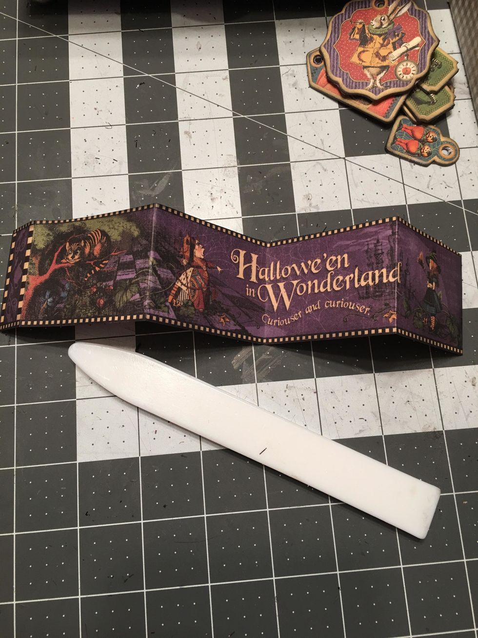 Create fun elements for your tag album such as this fold out that is cut out of the 12x12 paper. Fold into equal parts and burnish the fold lines with a bone folder.