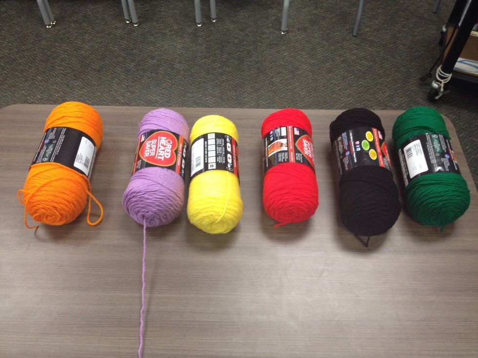 Create interest and interactivity by adding colored yarn. The yarn will be used to construct the web.