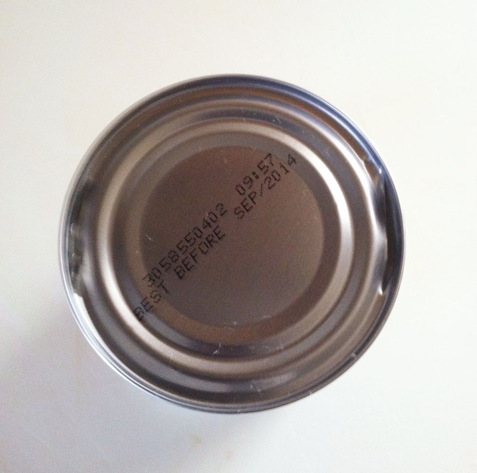 Create openings on opposite sides of the can.