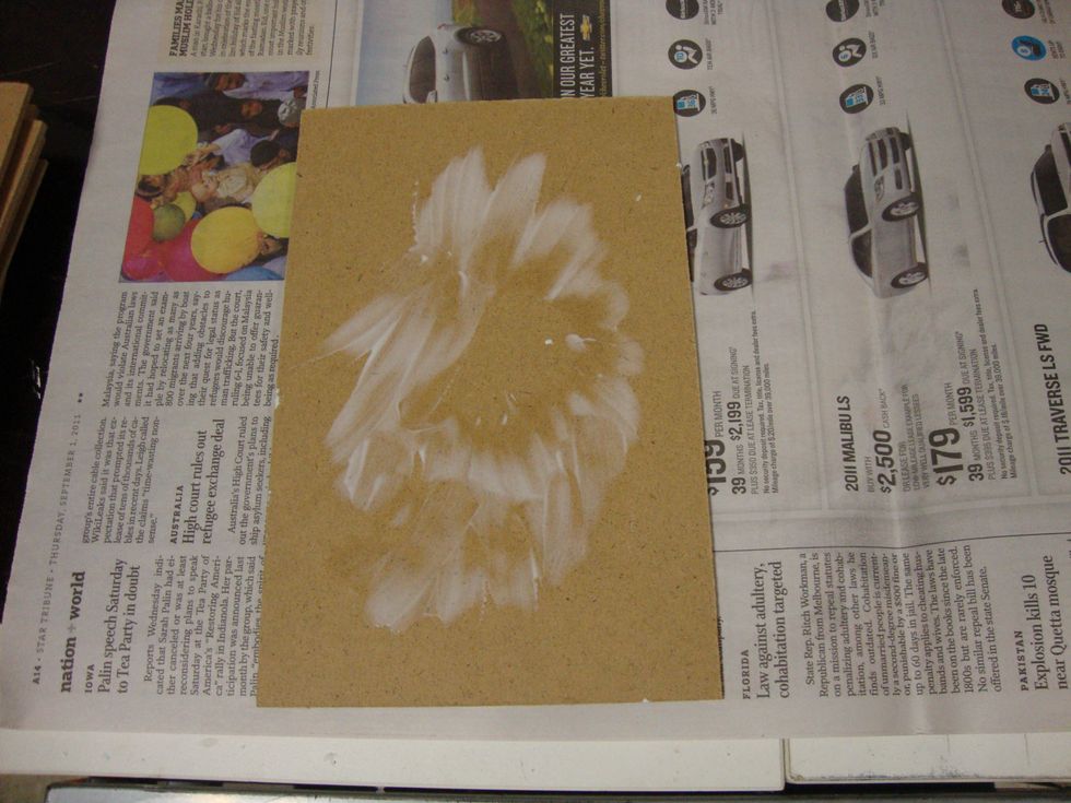 Create texture: Spread glue in a nonuniform fashion; keep the center clear as this will be the where the sunburst design converges.