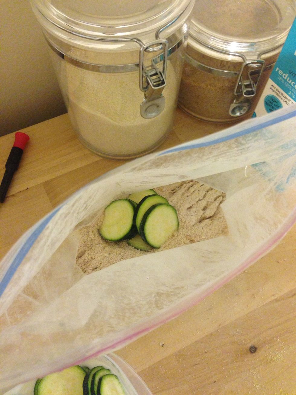 Create the breading out of 1/2c flour, 1/2c of corn meal, 2 tbsp chili powder, 1 tsp of Cayenne powder, 1 tbsp garlic salt, 2 tsp paprika, and 1 tsp Parmesan cheese. Add the sliced to the mixture.