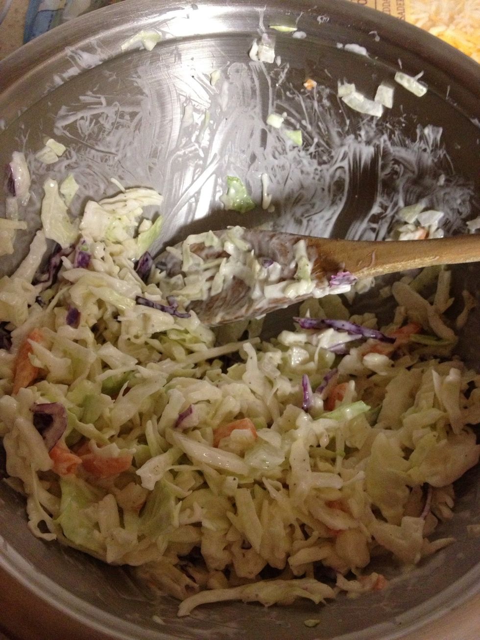 Create the slaw by mixing the onion, slaw/chopped cabbage and ranch dressing.
