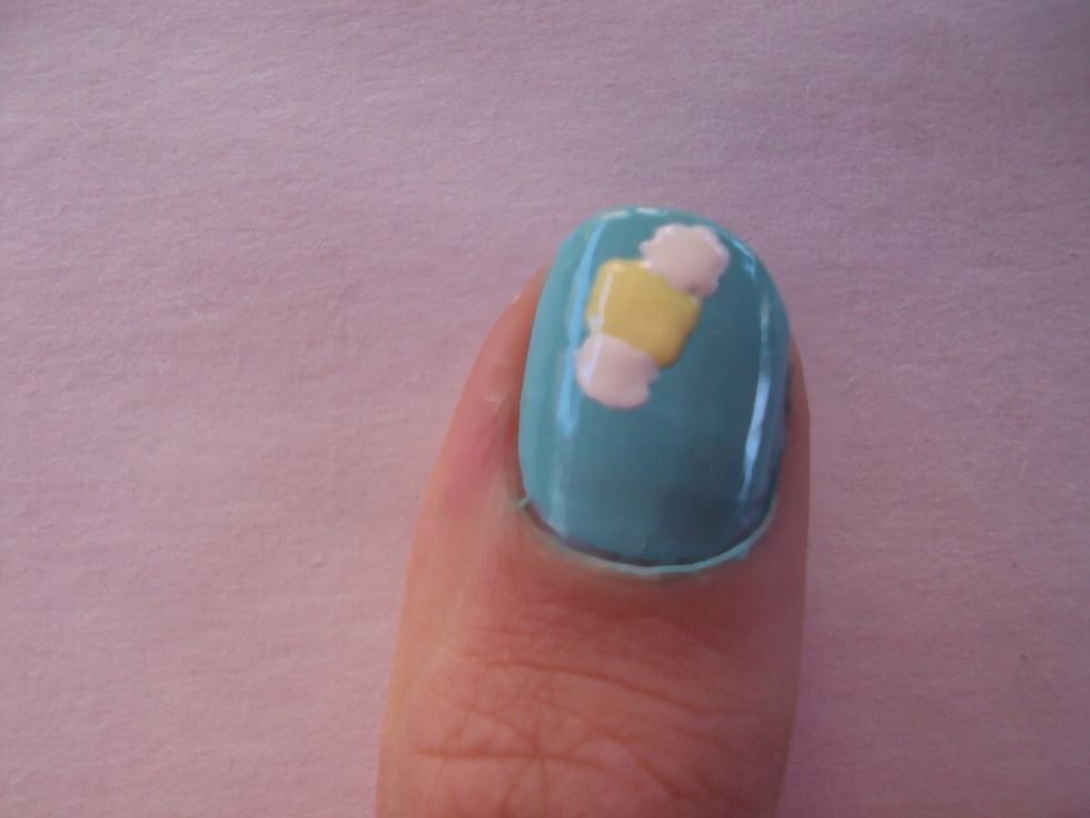 create the wings on the bee's yellow body. again it doesn't need to be perfect