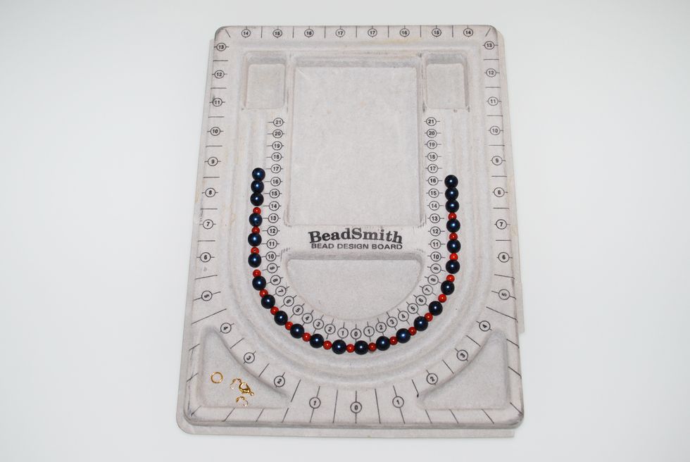 Create your design by laying out your stones on the tray track. Account for ~ 1/4" space between each stone to accommodate for the knot that will appear between each stone in the finished piece.