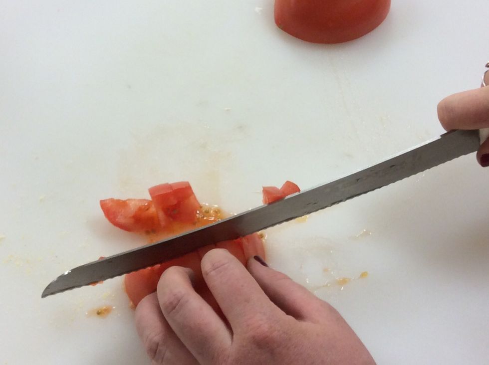 Cross cut the tomato to make it a dice.