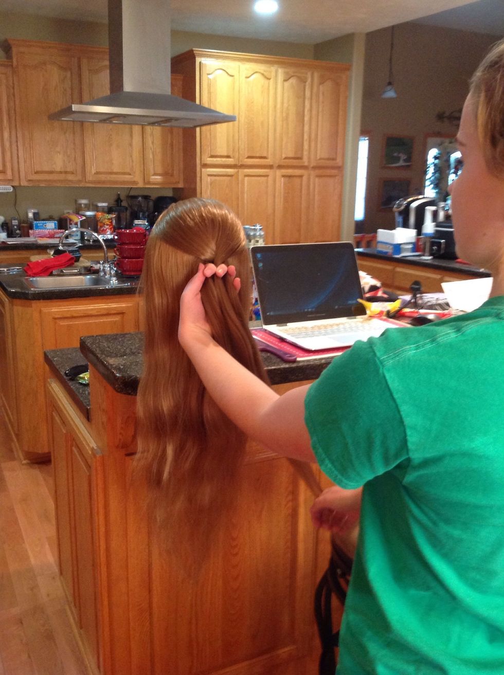 Cross over the other outside piece so that it replaces the one in the middle, again making sure it goes over the middle piece.