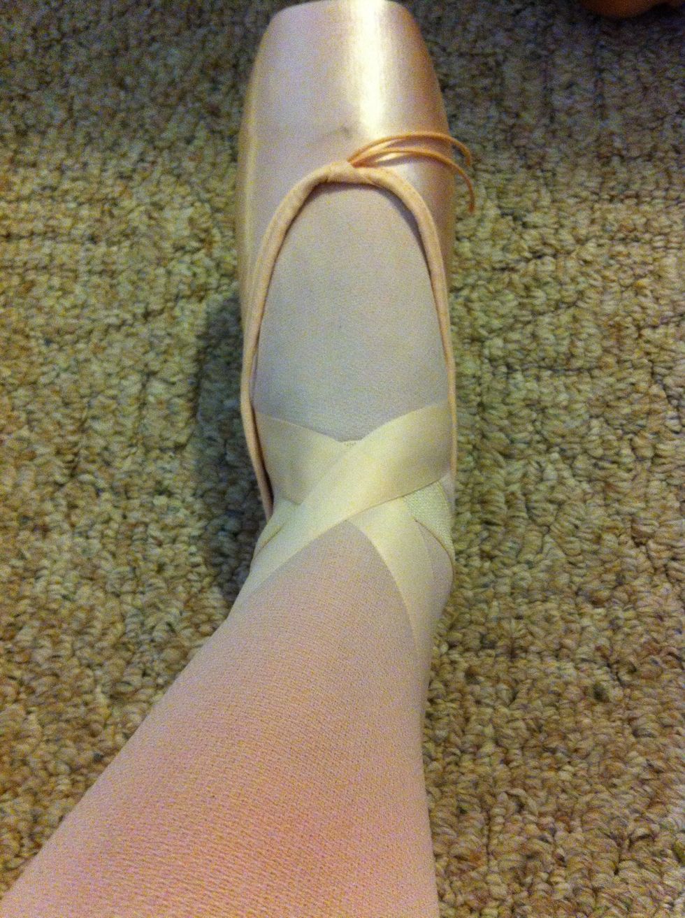 Cross ribbons over with your foot flexed up, so that when you stand up they won't be baggy or loose.