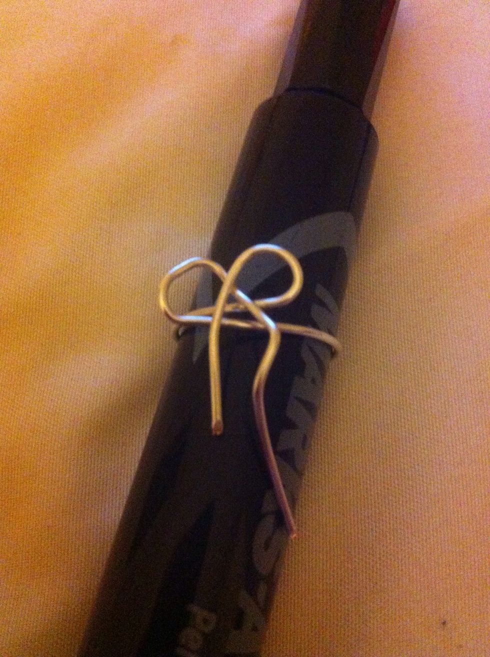 Cross the ends of the wires over each other. Take the top wire an pull it under the bow and back up and around.