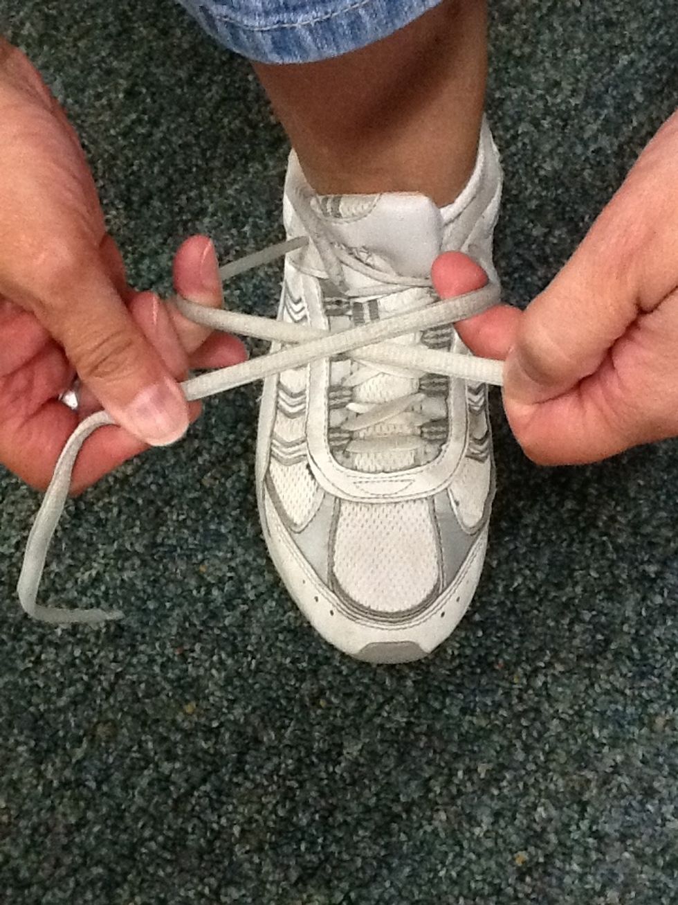 Cross the laces.
