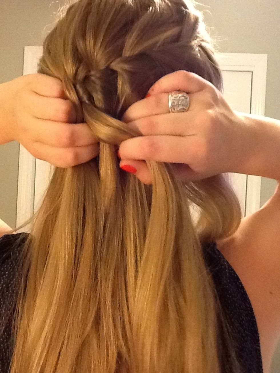 Cross the right section of hair over so it's the middle section.