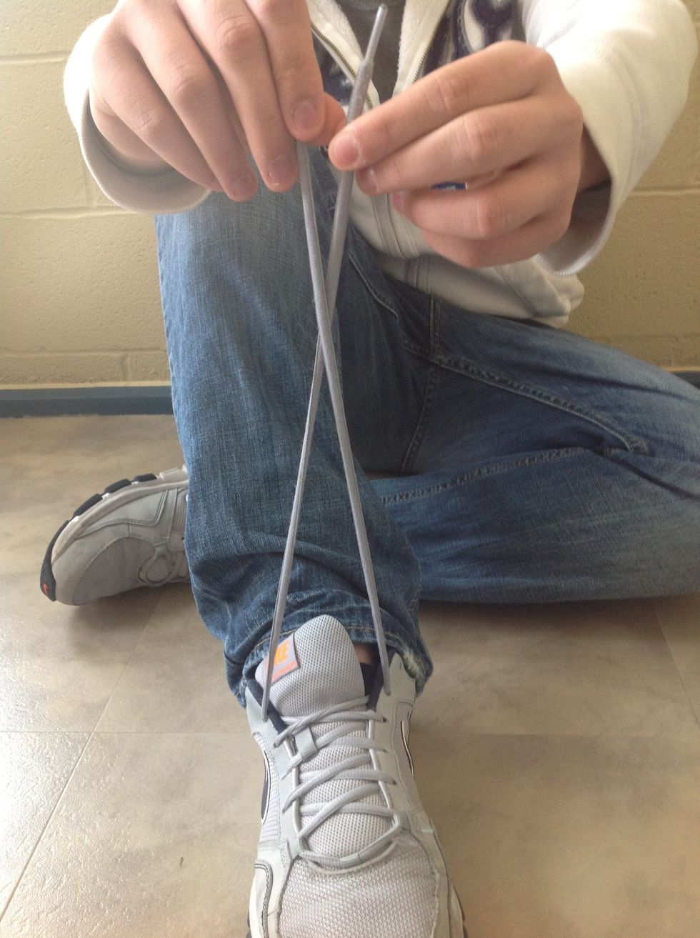 Cross the shoe laces over each other.