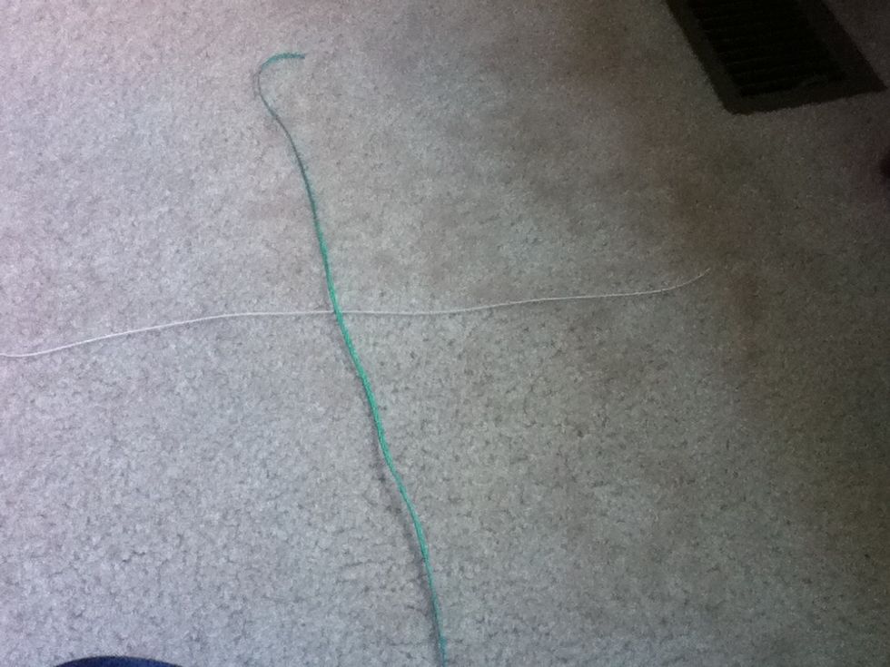 Cross the strings down the middle. Fold them if you are unsure if they cross in the middle. (Dose not need to be exact.)
