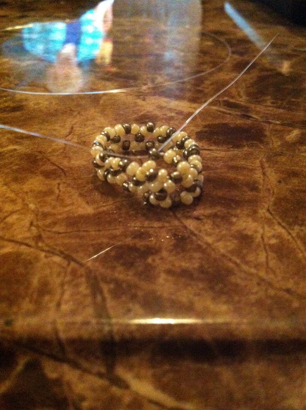 Cross through a silver bead to complete a circle