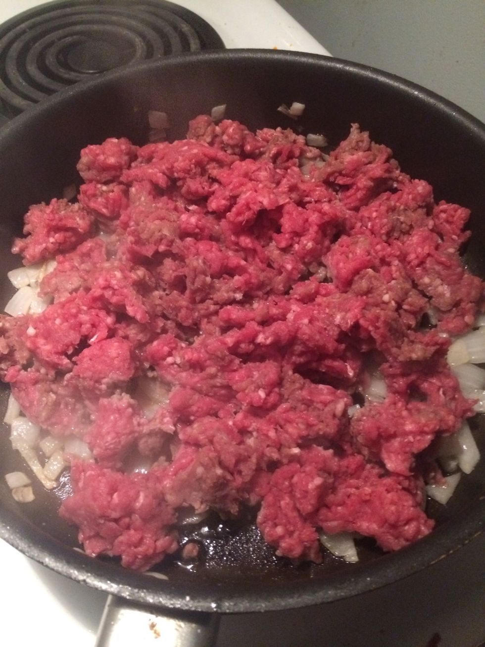 Crumble the beef with your (freshly cleaned) hands into the pan. This helps in keeping the beef easy to work with later on. As you continue to cook until brown, keep breaking up the beef with spatula