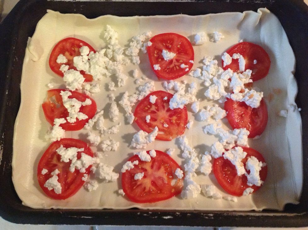 Crumble the fresh Gozo Cheeslets - Gbejniet Friski - on top of the tomatoes.