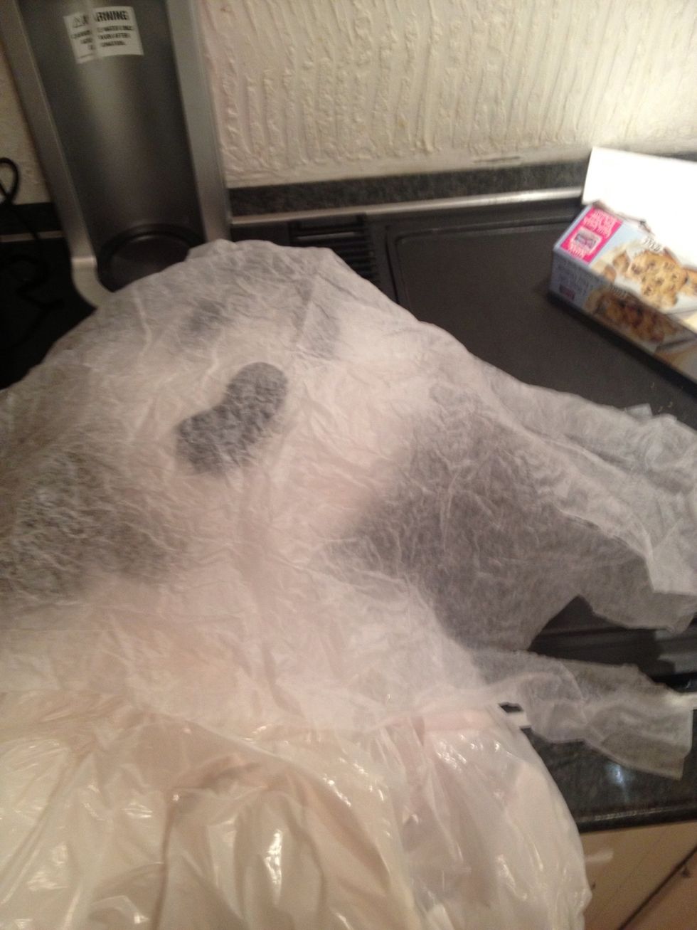 Crumple wax paper or even iron if you feel real pro style (to remove the shine. Stretching the plastic will also help remove shine from the bags! Either Staple or hand sew the wax paper over head.