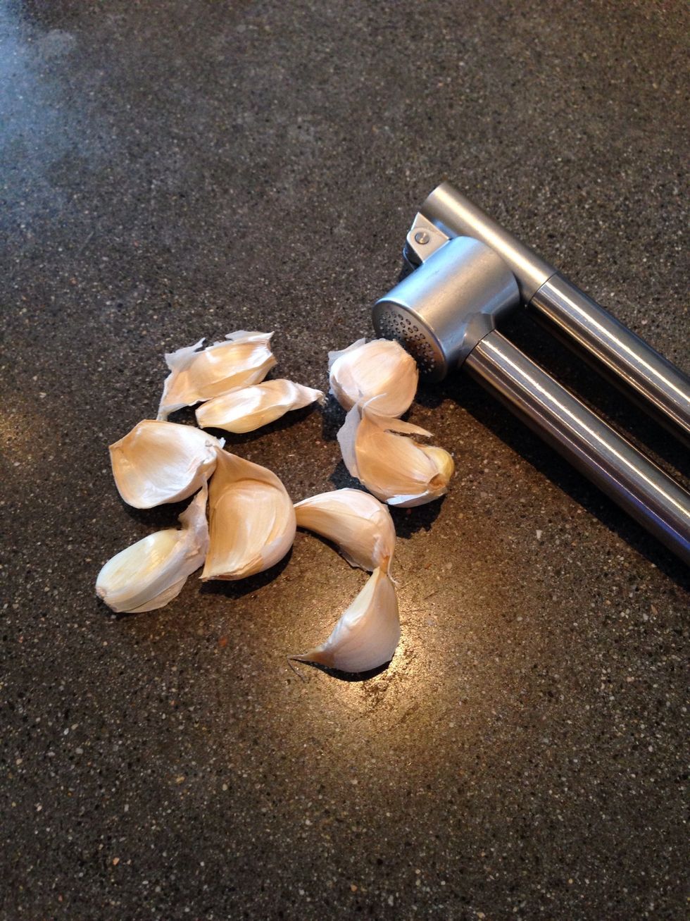 Crush 6 to 9 medium garlic cloves. Throw away the thin skins that come out when you crush the garlic as they will make the butter sauce lumpy.