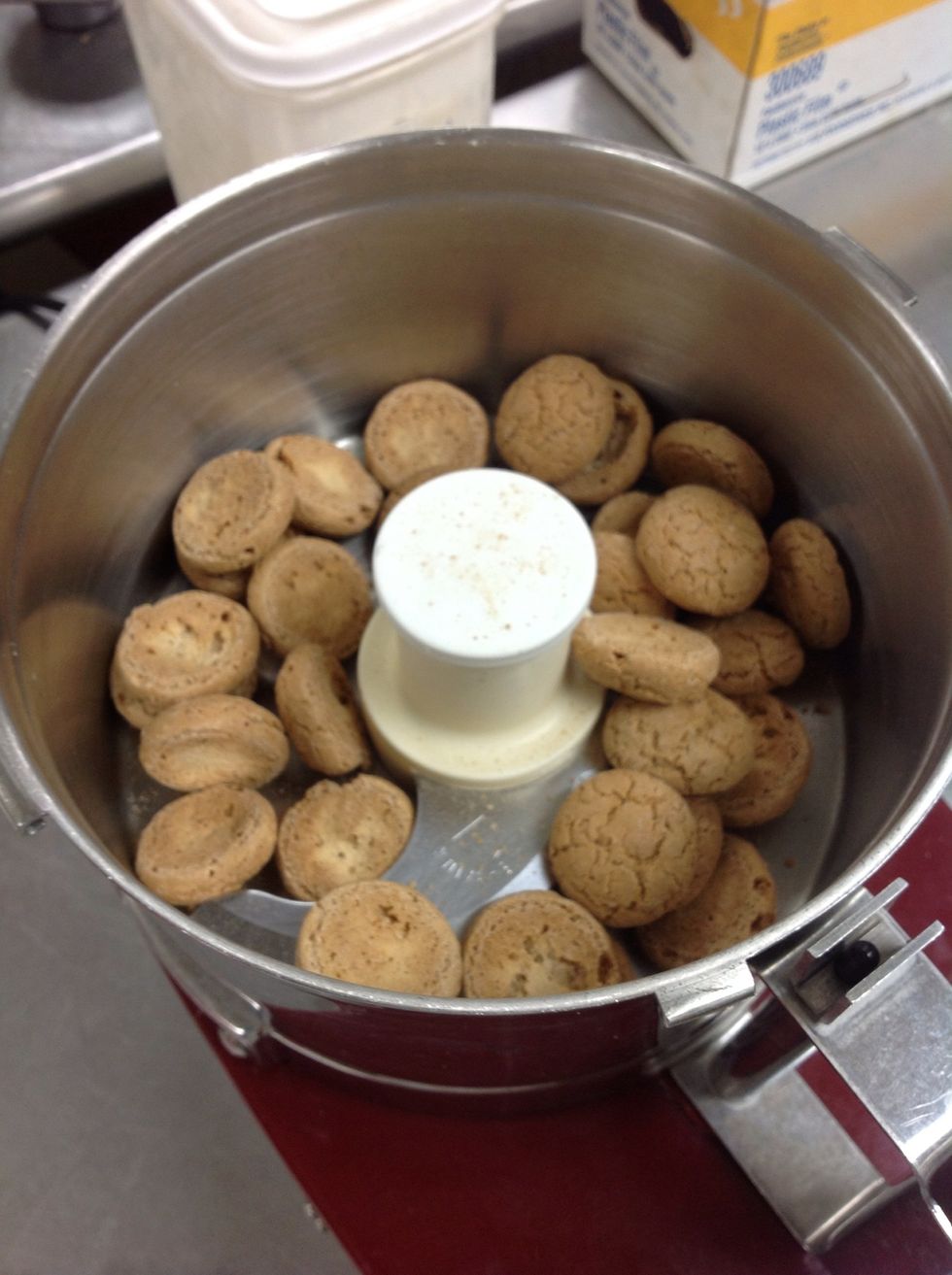 Crush amaretti cookies in a food processor.