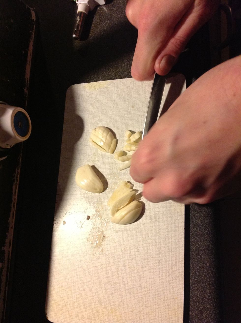 Crush and mince 2 cloves of garlic.