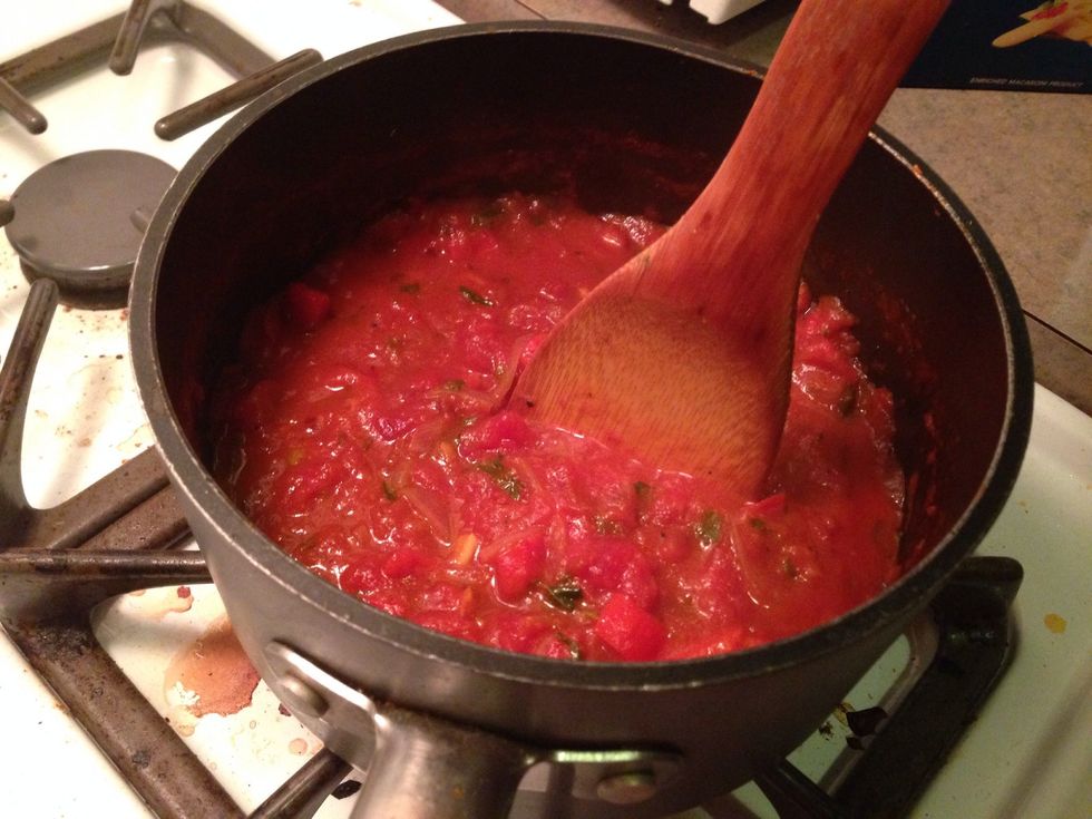 Crush any remaining chunks of tomatoes until you reach your ideal sauce consistency.