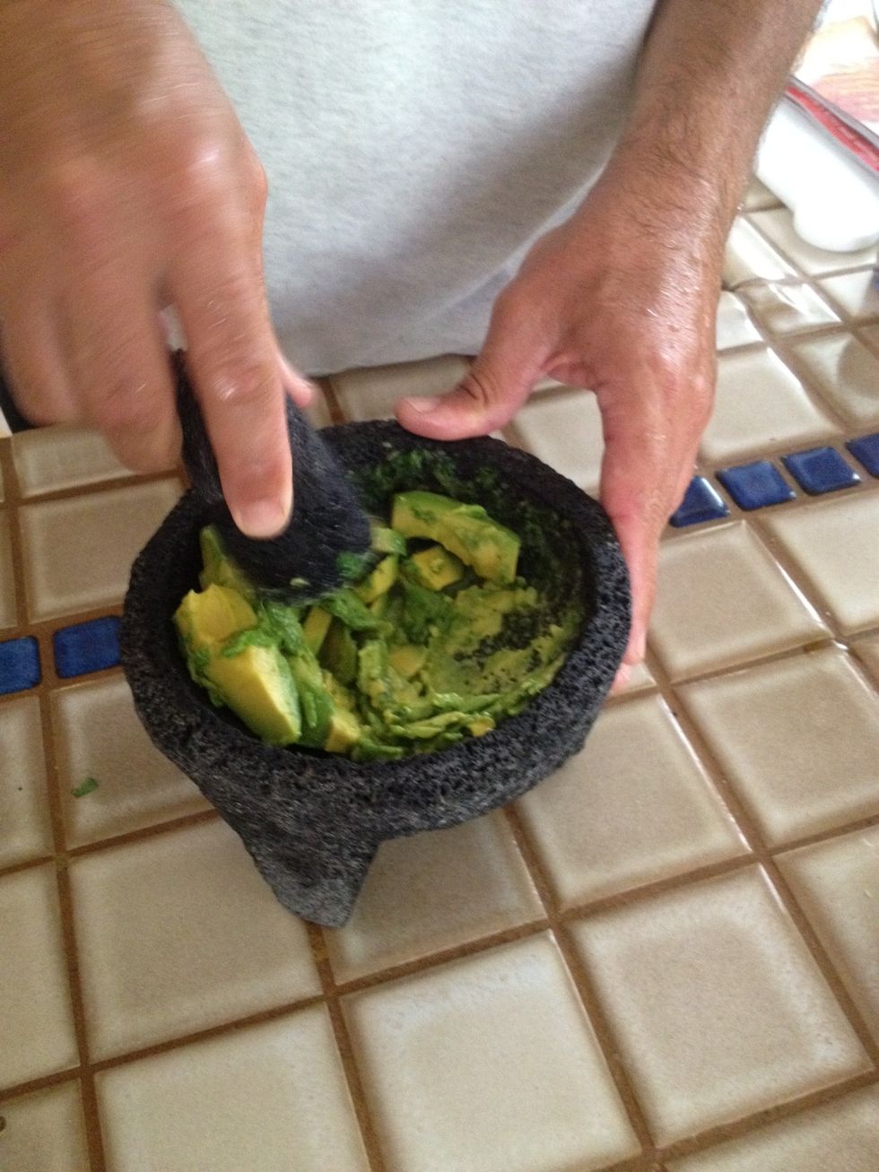 Crush avocados into mixture.