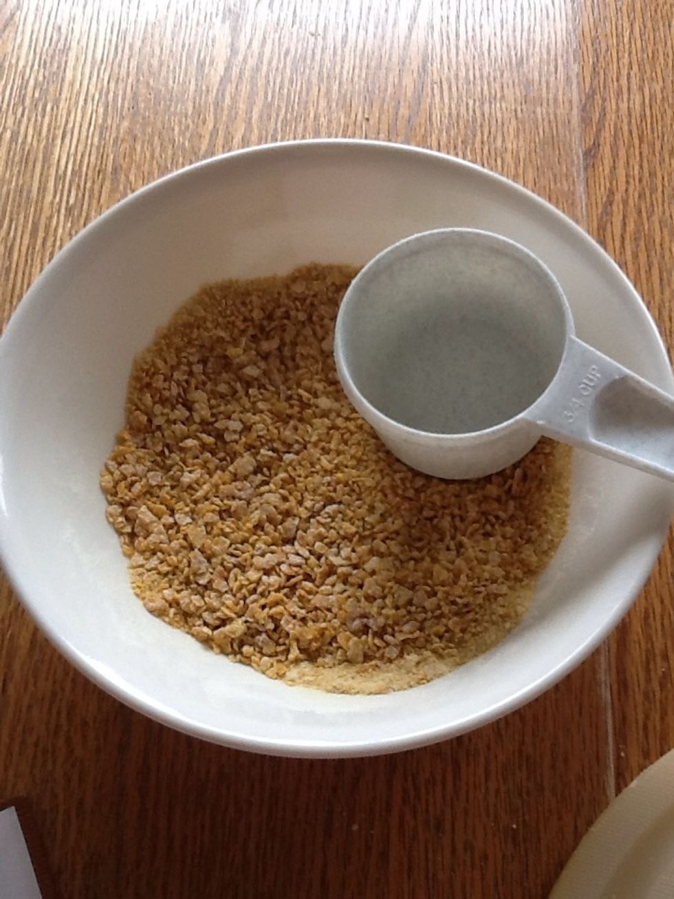 Crush cornflakes with the back of a measuring spoon. Kids will love to help with this step.