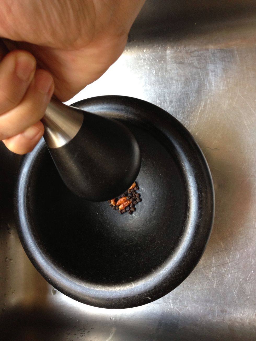 Crush pepperoncini and black peppercorns . Add to the skillet over the onions...