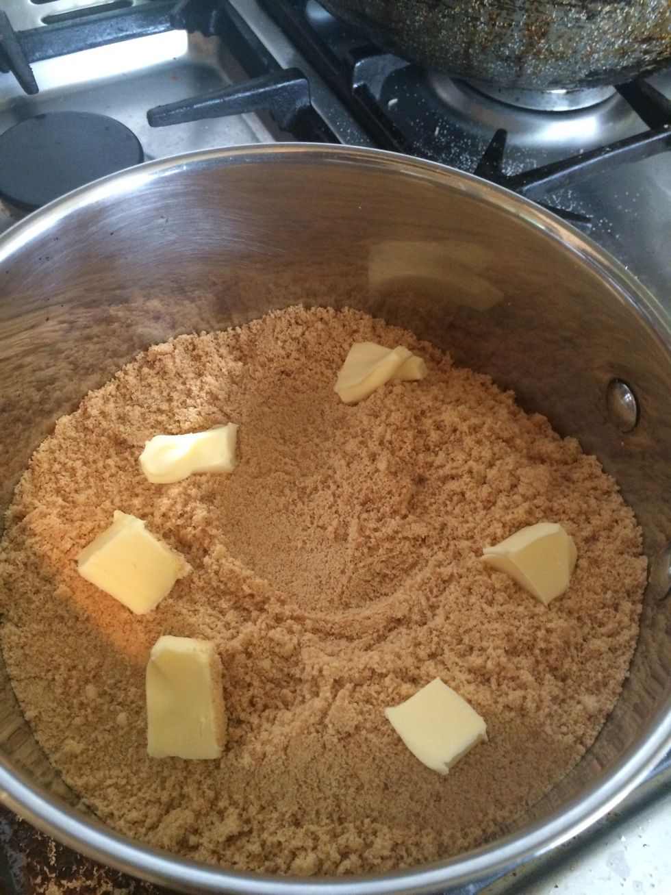 Crush the biscuits using a rolling pin and then a blender/food processor so it's extra smooth. Place in a pan with butter on low heat.