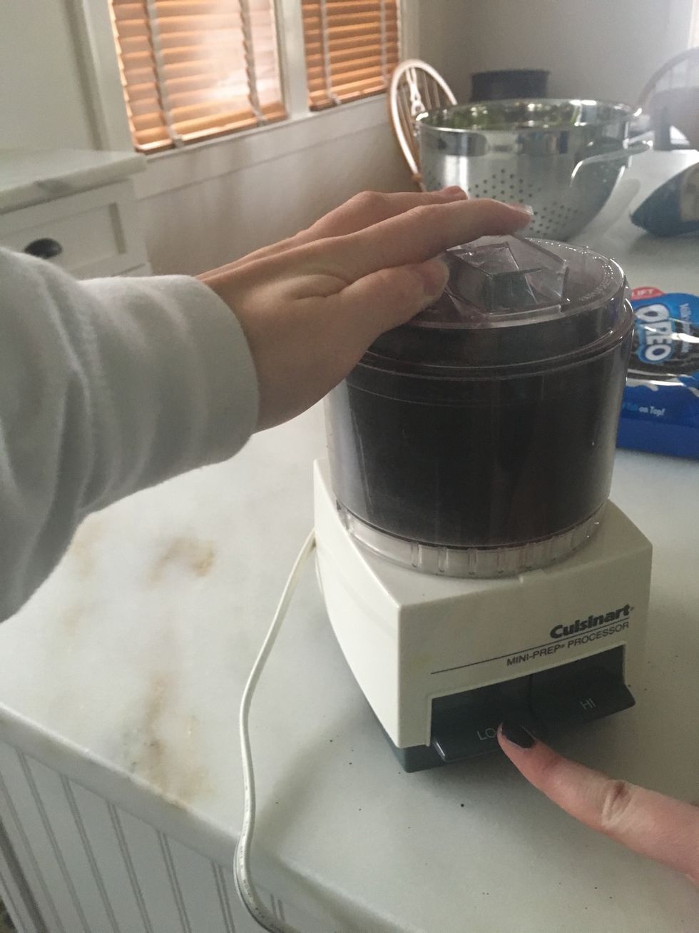 Crush the entire bag of oreos into a fine powder with either your food processor or by hand.