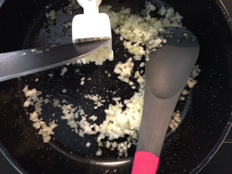Crush the garlic over the onions and continue to cook on medium heat... Then