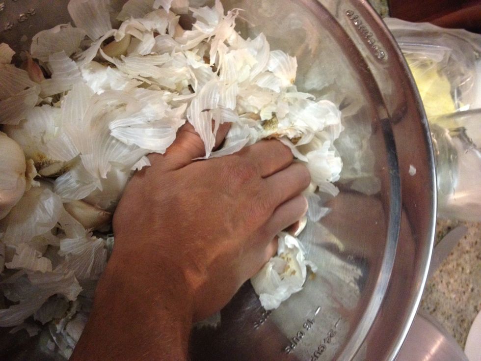 Crush the heads with the base of your palm and the head will break apart into cloves.