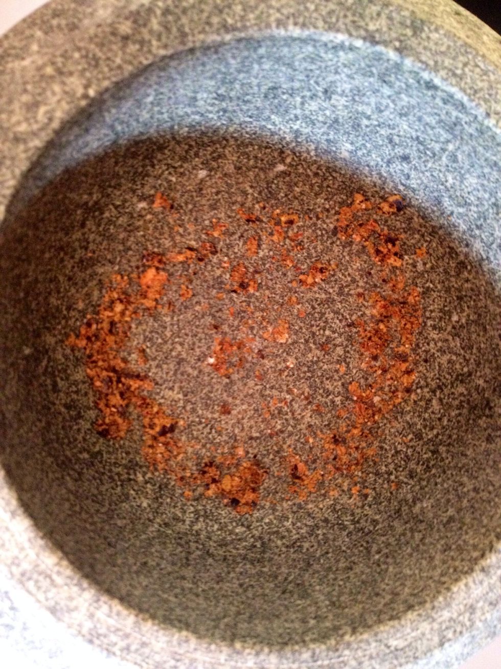 Crush the juniper berries using a pestle.