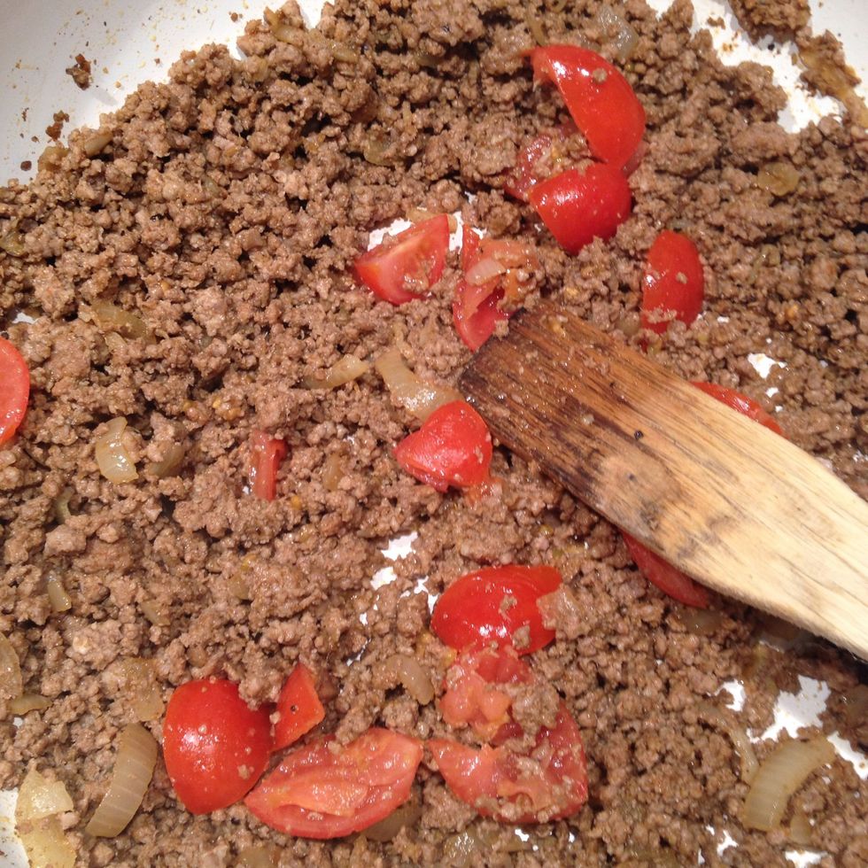 Crush the tomatoes into the mix. Add half a cup of water, not too much.