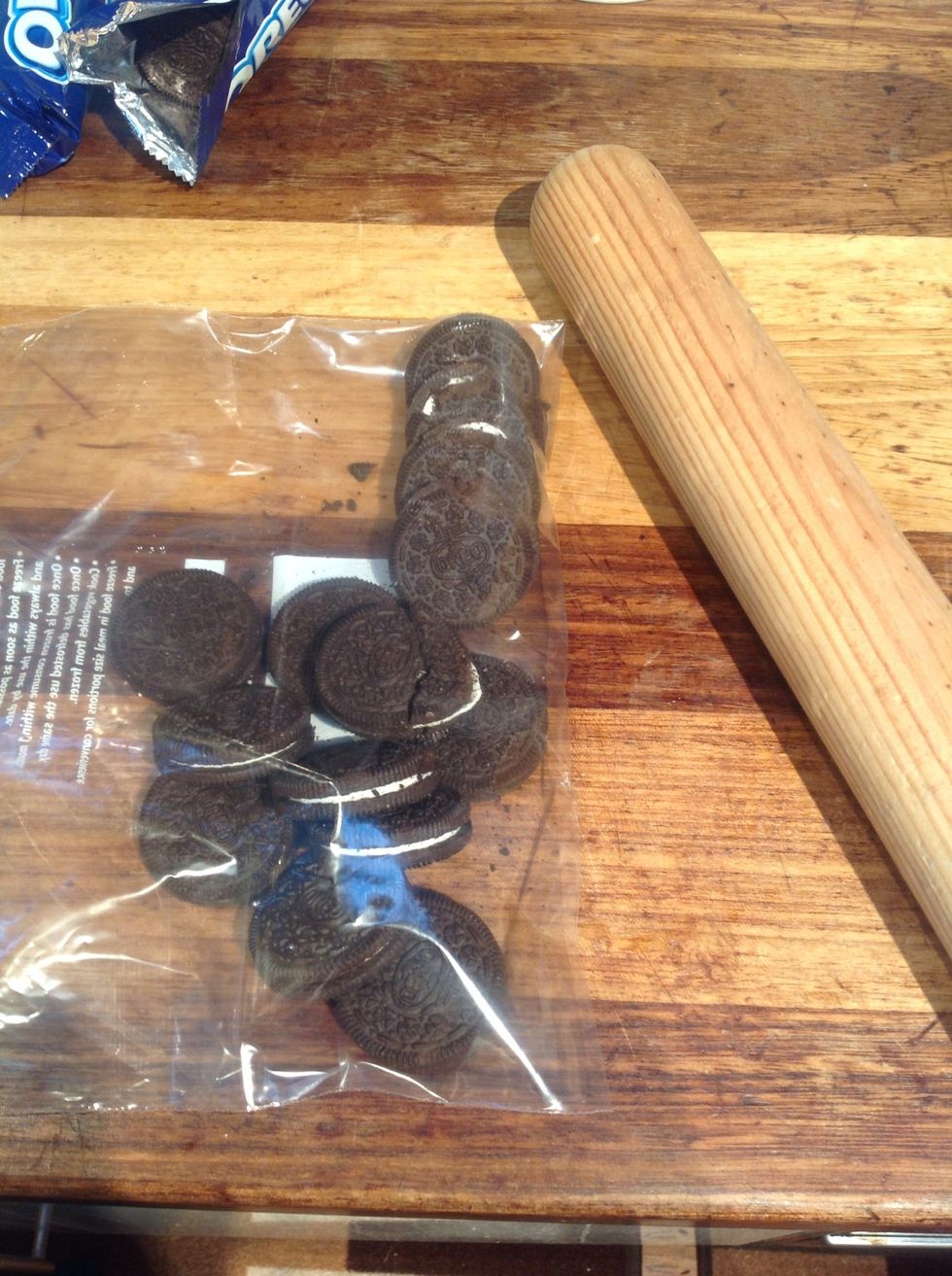 Crush two Oreo packets with a rolling pin (you might need more depending on how big the tin is)
