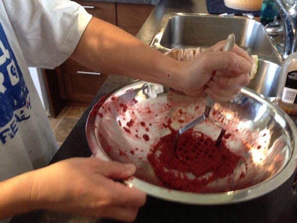 Crush your fresh raspberries using a potato masher.