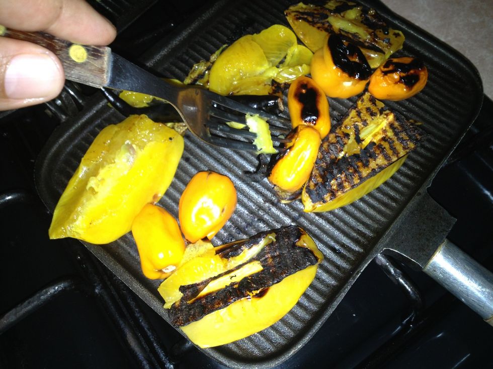Cuando los carambolos y chiles esten asados voltearlos para asar la otra parte.