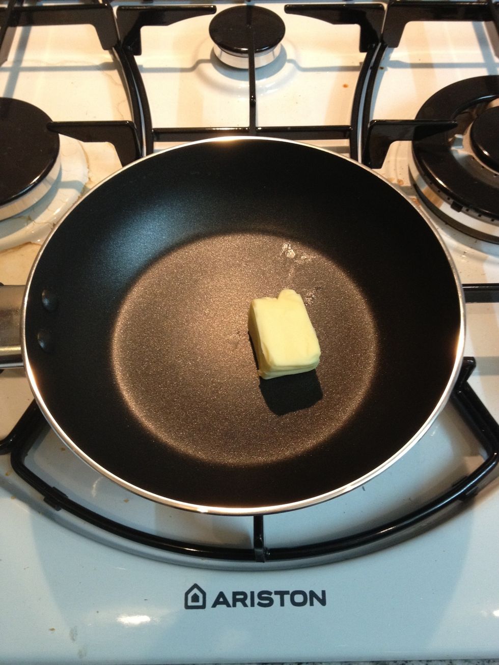 Cube of butter in a pan. (Garlic butter if possible)