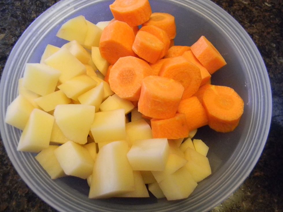 Cube the potato and slice the carrot.